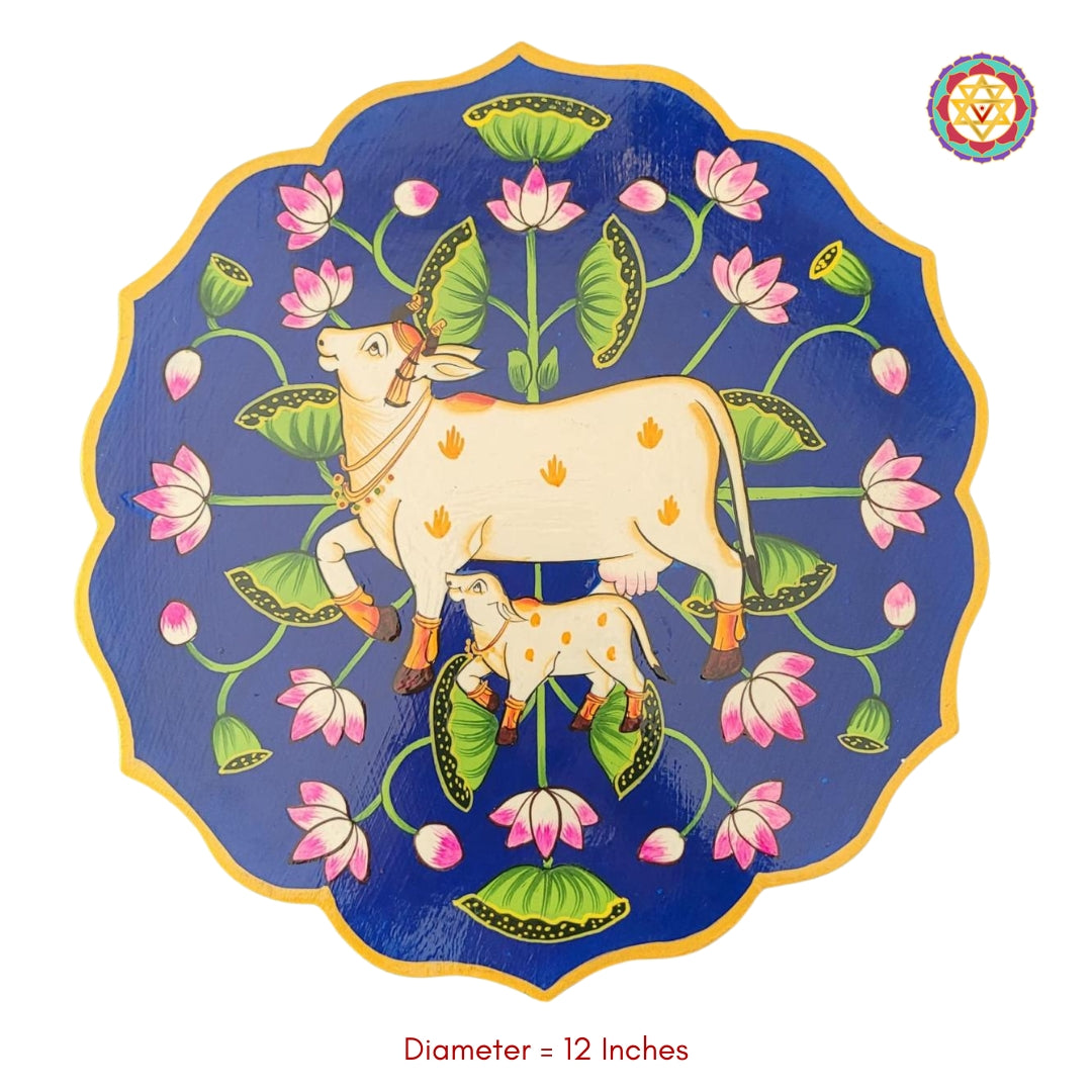 12-inch yellow pichwai wall art plate with hand-painted cow, calf, and lotus pichwai painting. Decorative plate for Indian-themed decor.