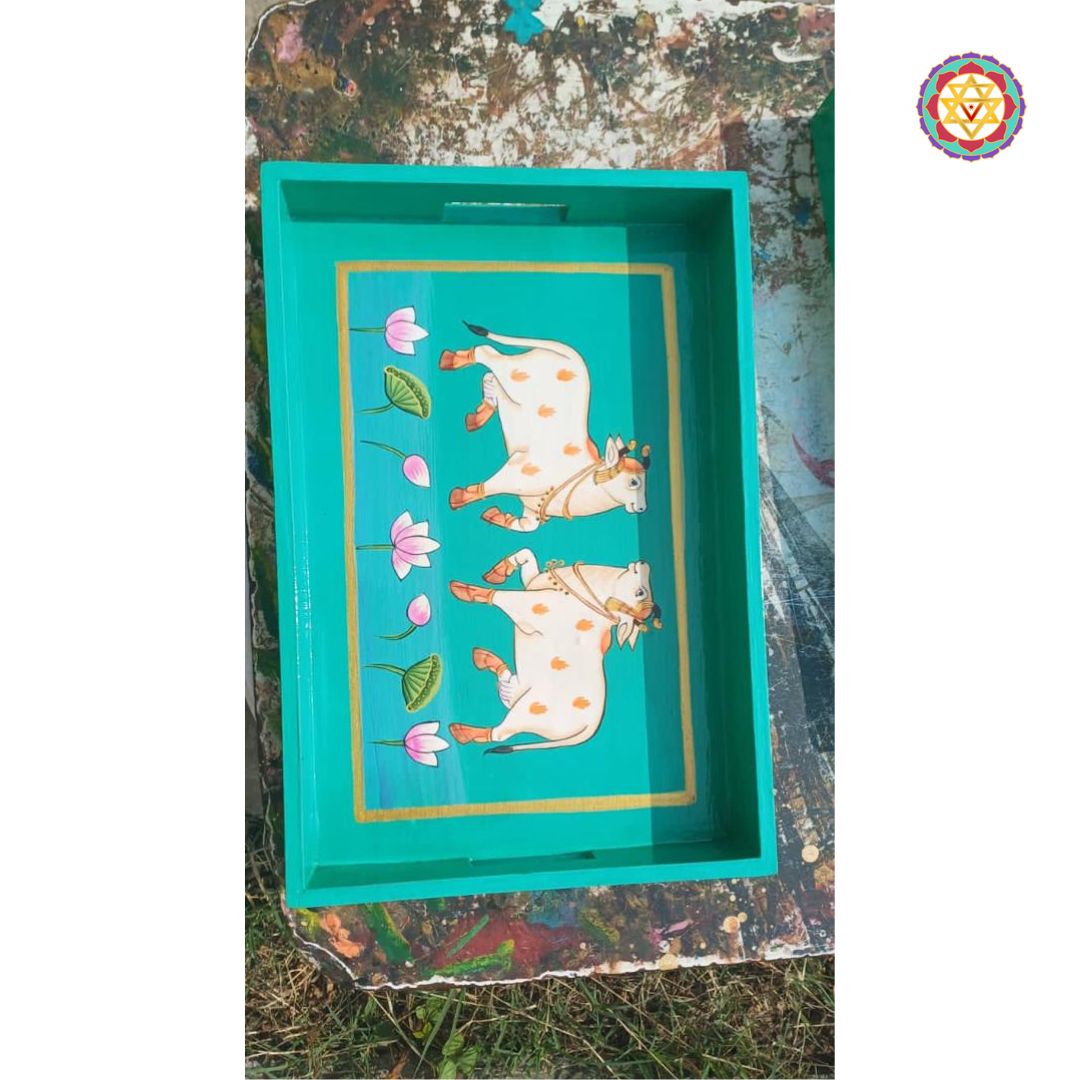 Side view of rectangular hand-painted Pichwai tray with cow art and floral details.