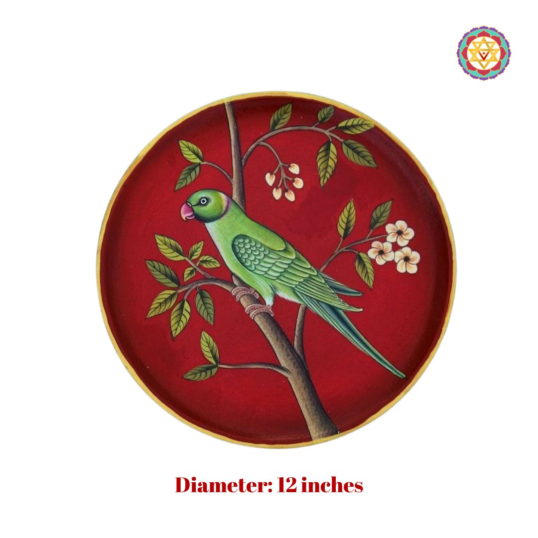Handpainted wall plate of parrot on red background with traditional floral accents.