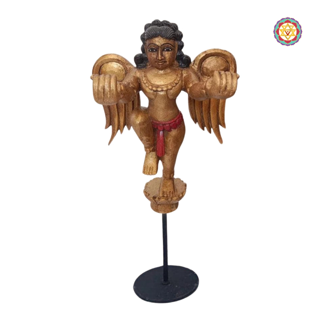 Close-up of Gandharva tabletop sculpture highlighting wing carving and facial details — handcrafted devotional wooden art