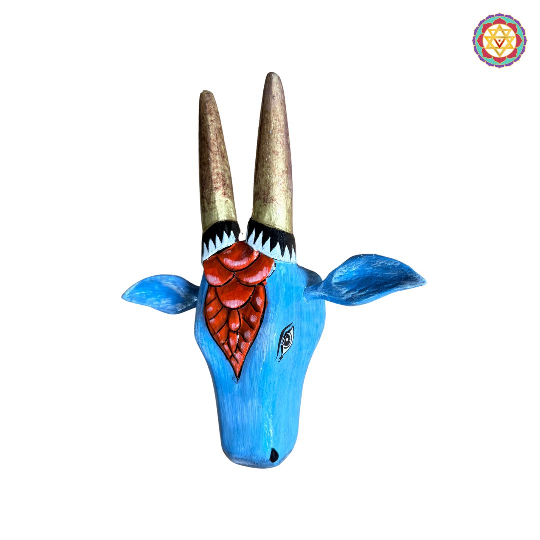 Red and blue Nandi cow head traditional woodcarved wall decor closeup