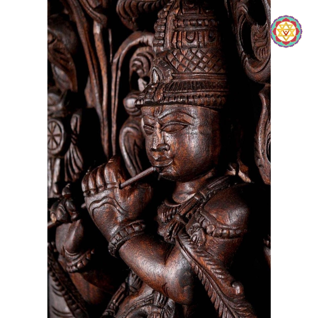 Close-up of Krishna statue showing serene expression, flute, and carved jewelry details