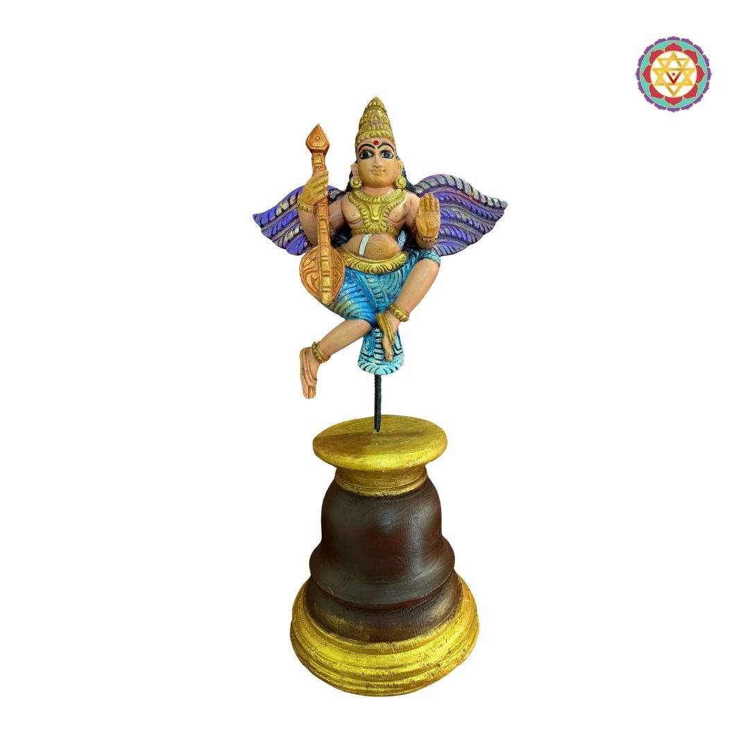 Beautifully handcarved Gandharva (Indian Angel) playing the Veena, crafted on a sturdy wooden stand.