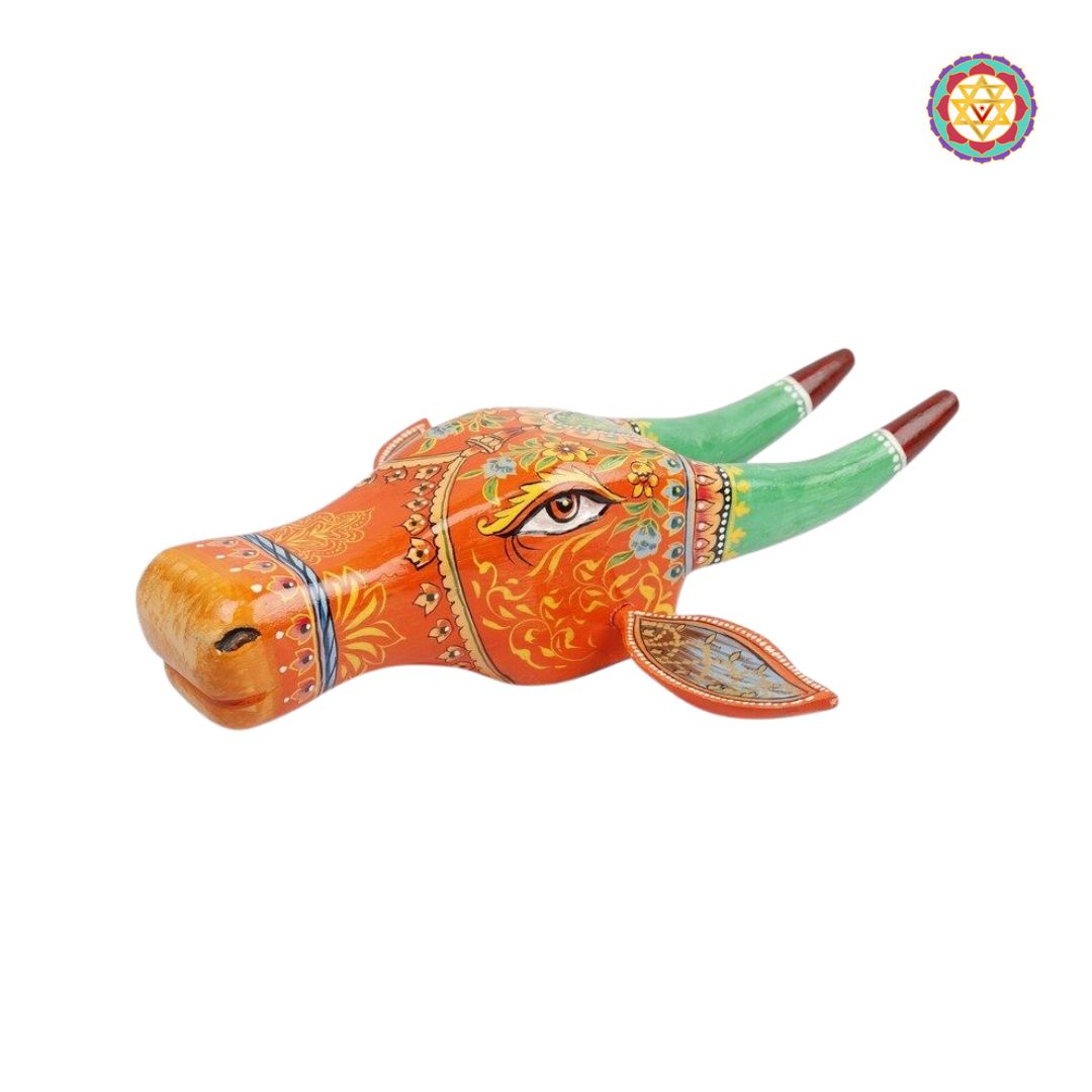 Close-up of Nandi cow head showing detailed floral artwork and carving