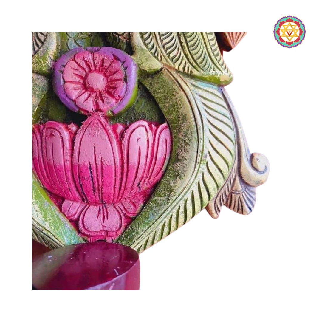 side view of peacock and lotus deepak holder showing carved detailing and antique finish