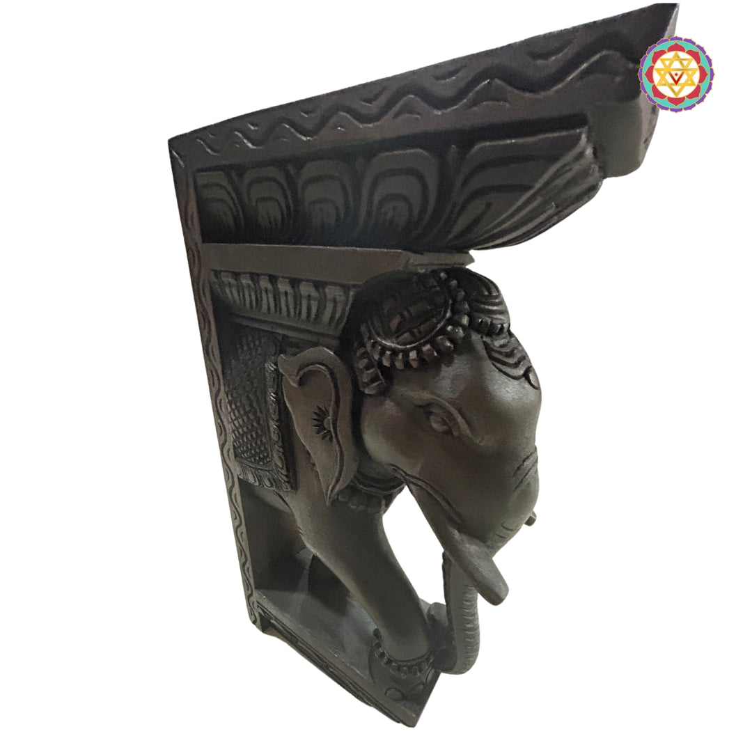 Side view of intricately carved wooden Ganesh bracket in rosewood finish