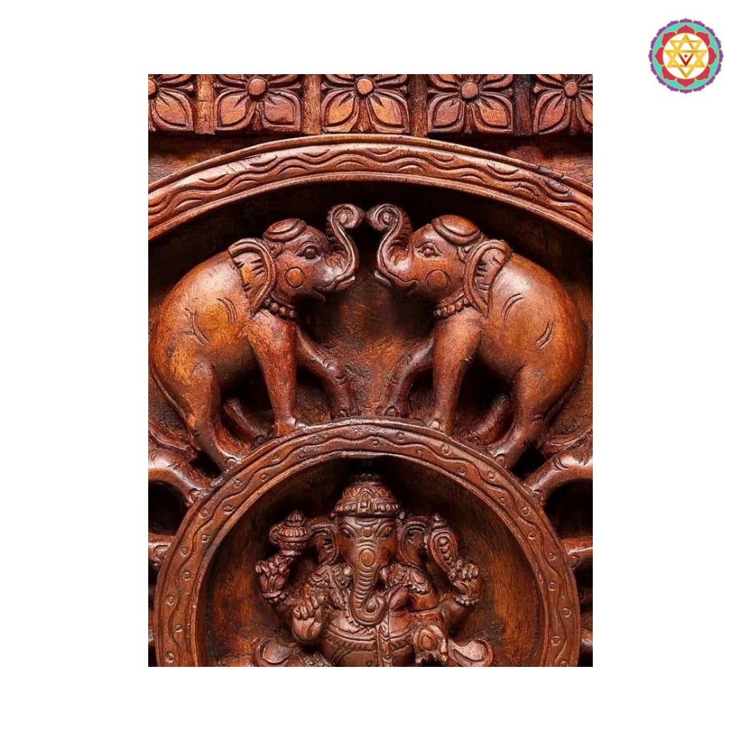 side view of elephants carving around central ganesha motif