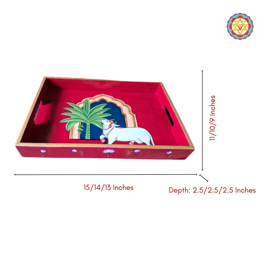 Studio-style flatlay of wooden tray showing Pichwai art with traditional sacred cow.