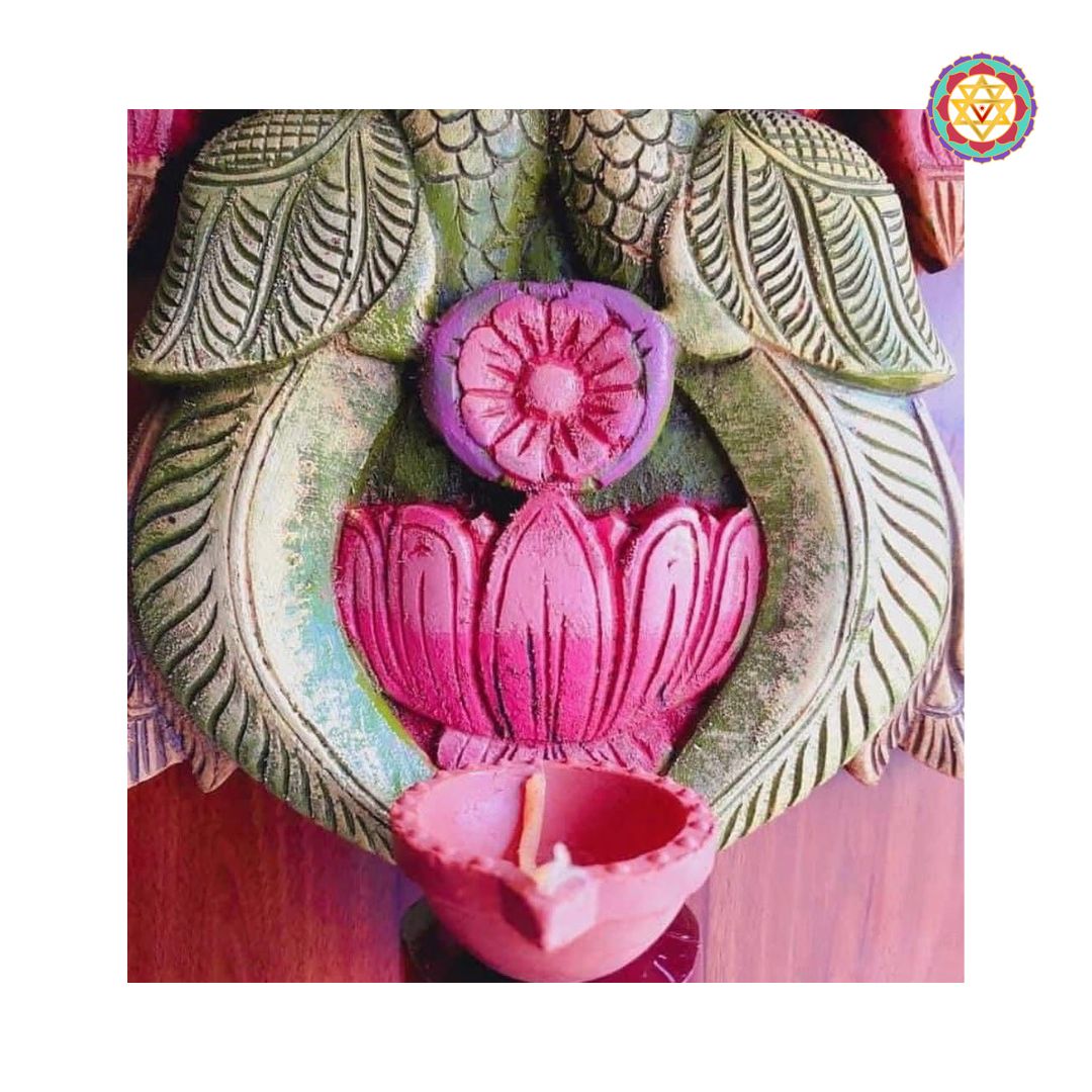 close up of lotus motif and lamp base on wooden vilakku handcrafted by artisans