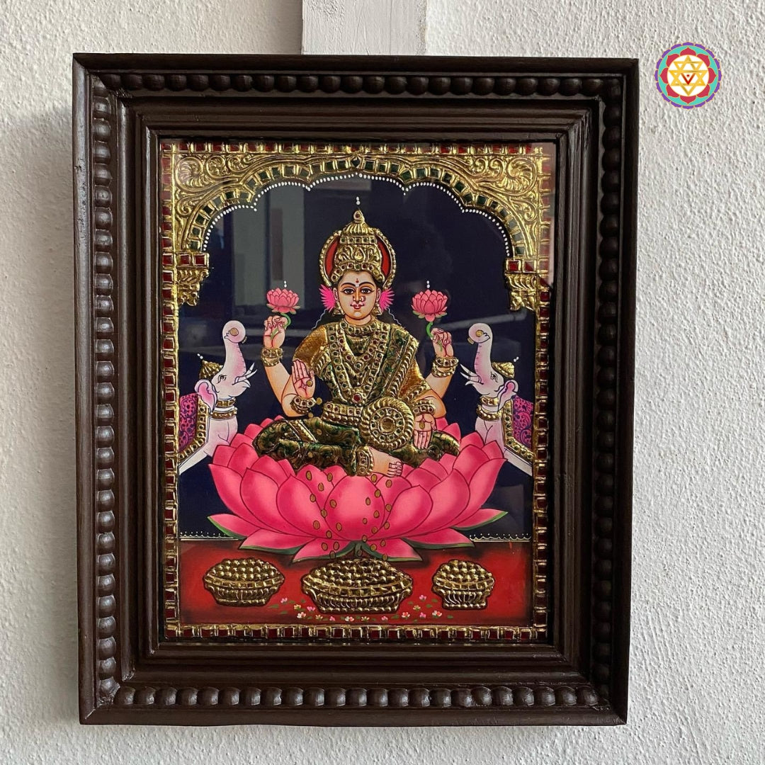 “Tanjore painting of Gajalakshmi in antique style, with pink lotus base and gold halo”