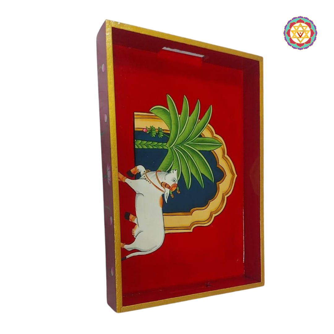 Detailed side shot of hand-painted Pichwai cow tray with golden trim.