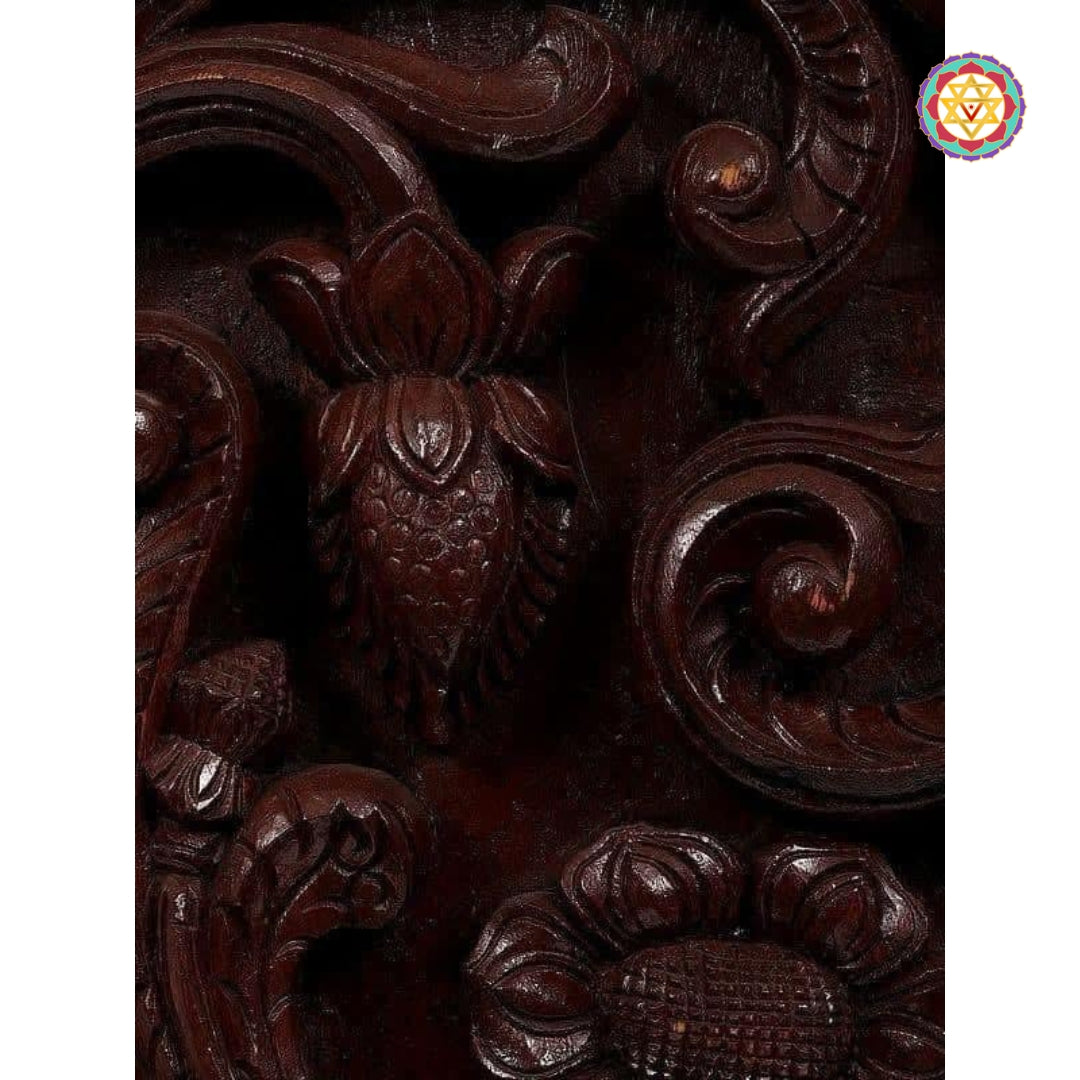 "Close-up of intricate Annam carving with floral details in dark polished wood"