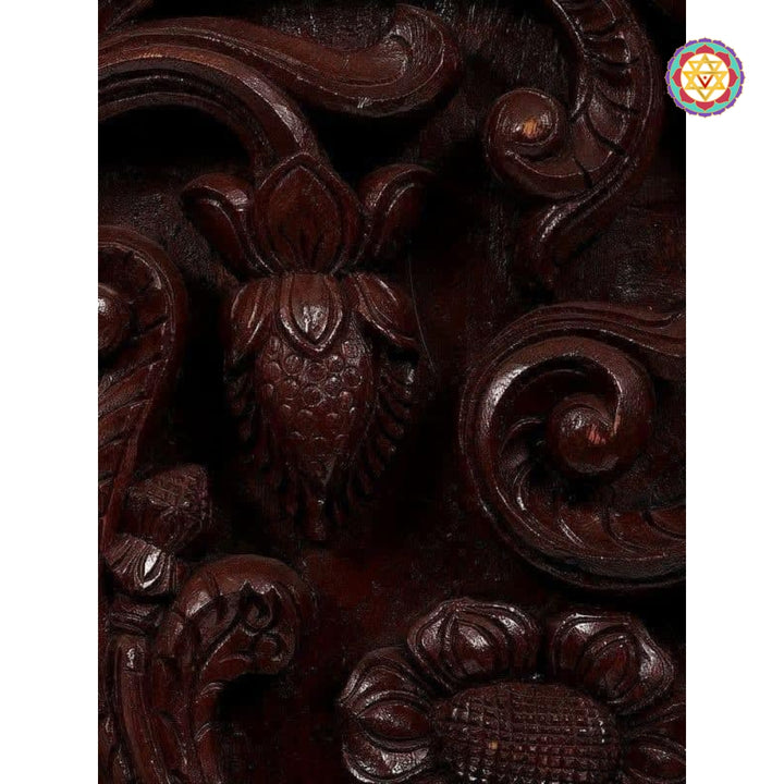 "Close-up of intricate Annam carving with floral details in dark polished wood"