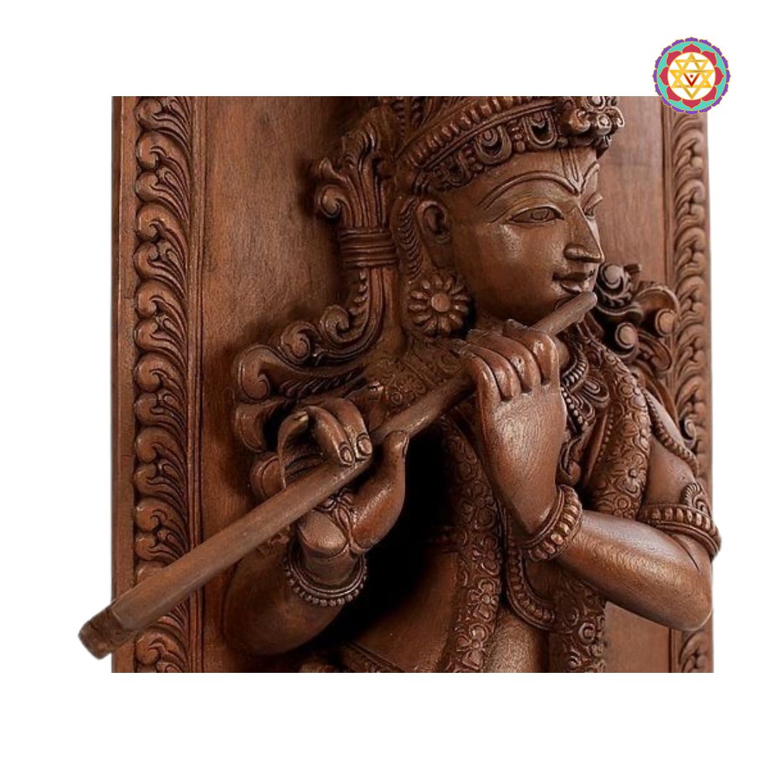 Wooden sculpture of a deity playing a flute with intricate carvings on a white background - Ornamental carvings on Krishna panel in natural wood finish