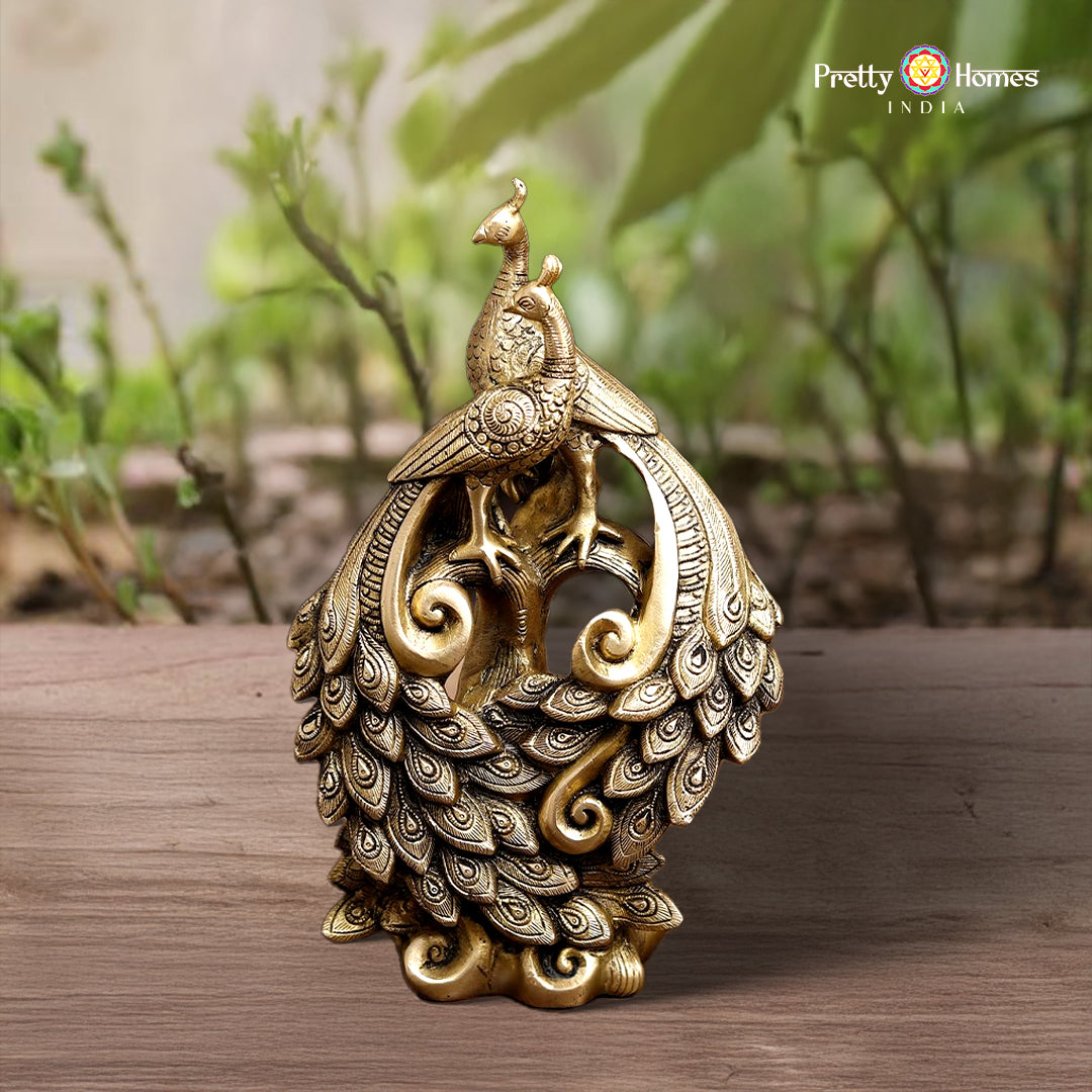 pair of brass peacock sculptures with elegant tail spread and golden polish