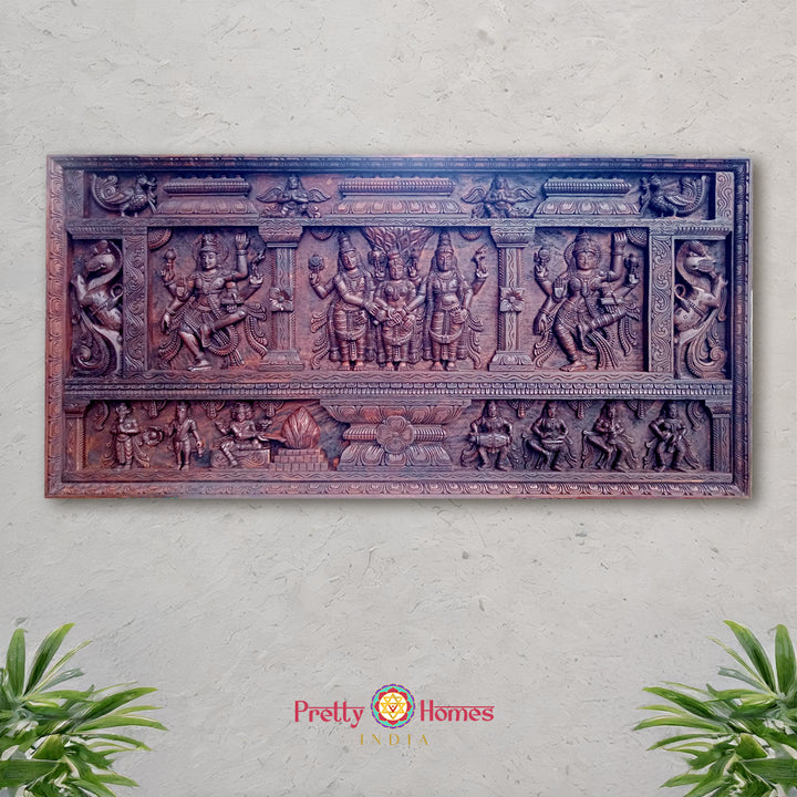 A hand-carved wooden wall panel depicting a scene with deities and musical apsaras. - Wooden carved wall panel of Meenakshi Kalyanam with deities and apsaras
