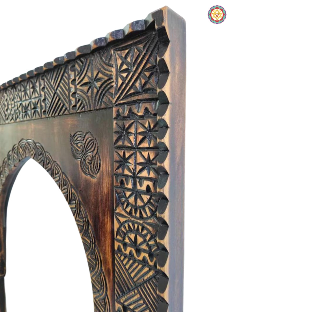 Side profile showing detailed carving on dark wooden frame