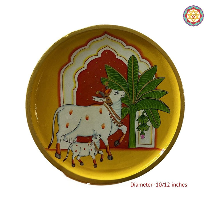 Handpainted yellow cow artwork with mehrab motifs on wall plate