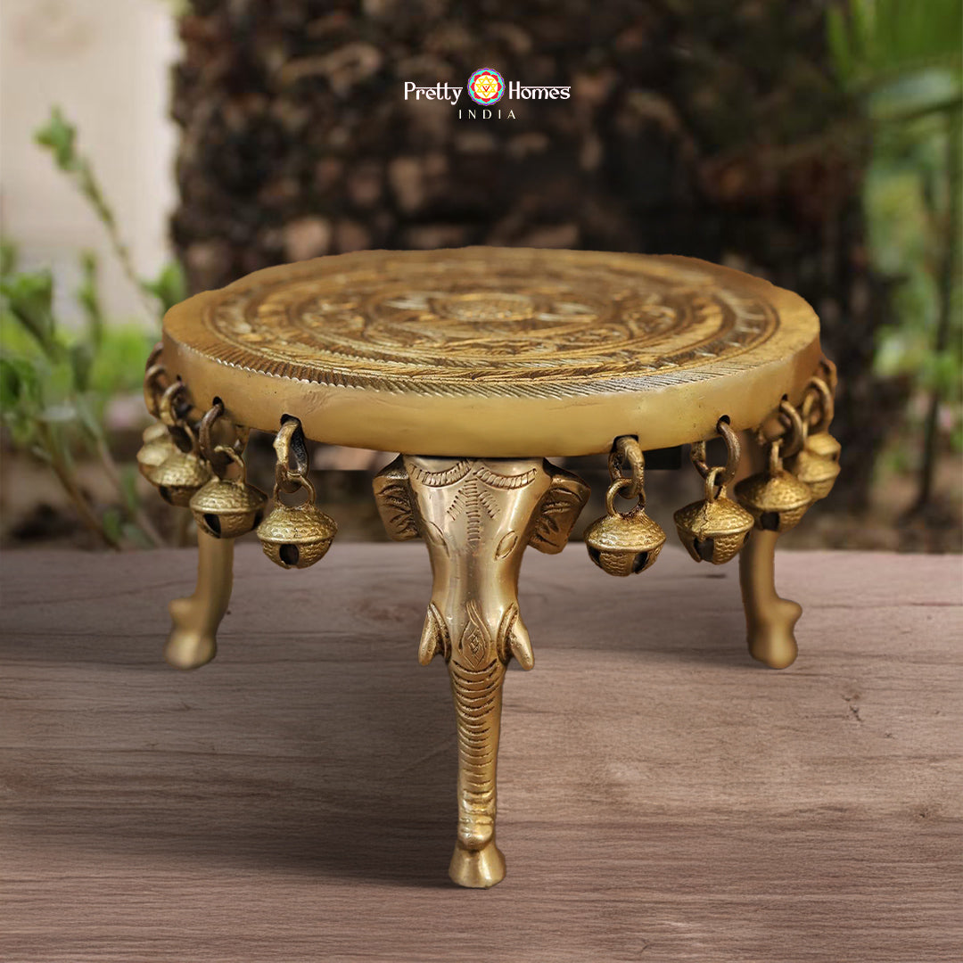 brass table with elephant legs and bells featuring traditional golden charm