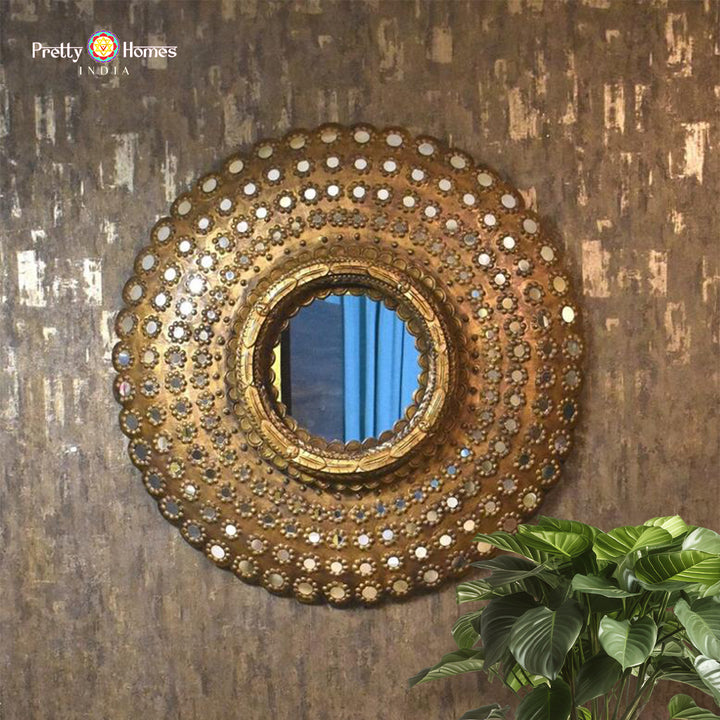 Large round wooden wall mirror frame mounted on textured wall