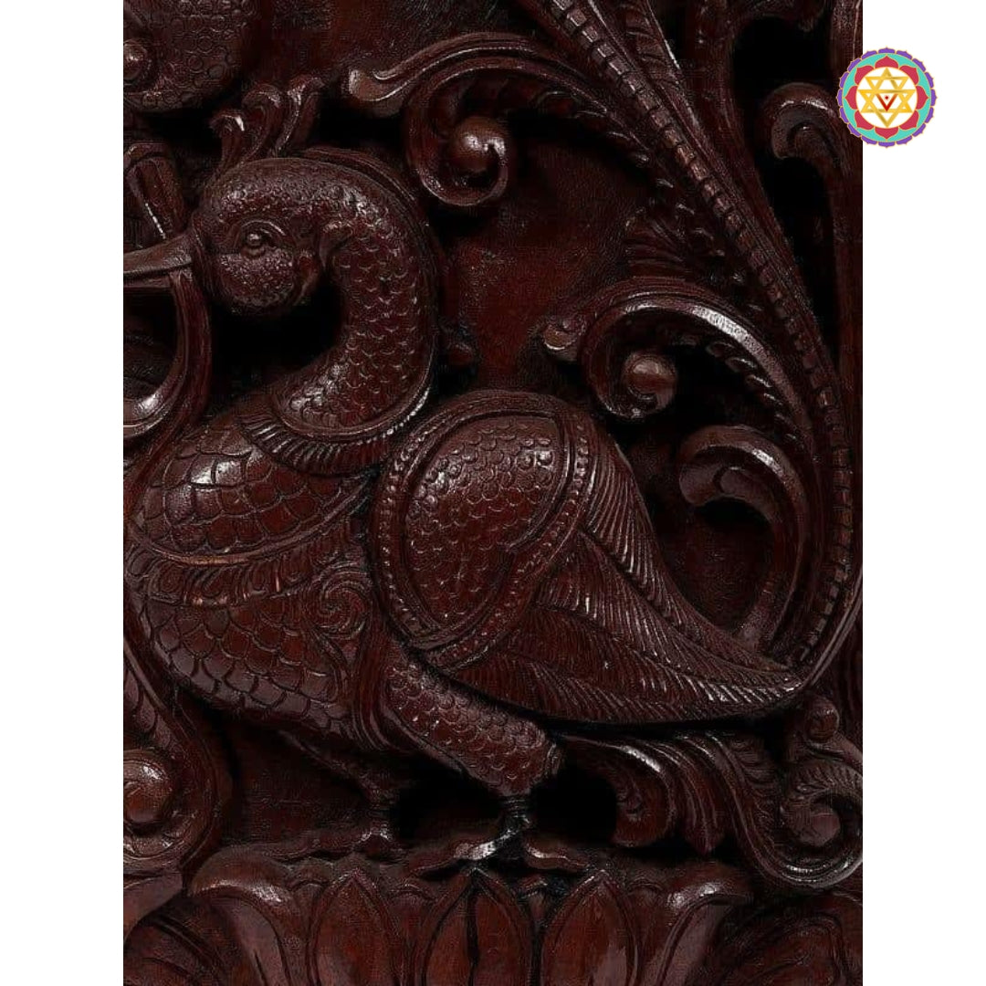 "Detailed lotus and vine motif in traditional wooden carving"