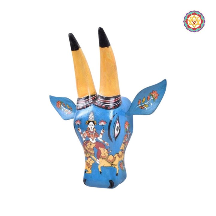 Close-up of wooden cow head decor with vibrant multicolour detailing