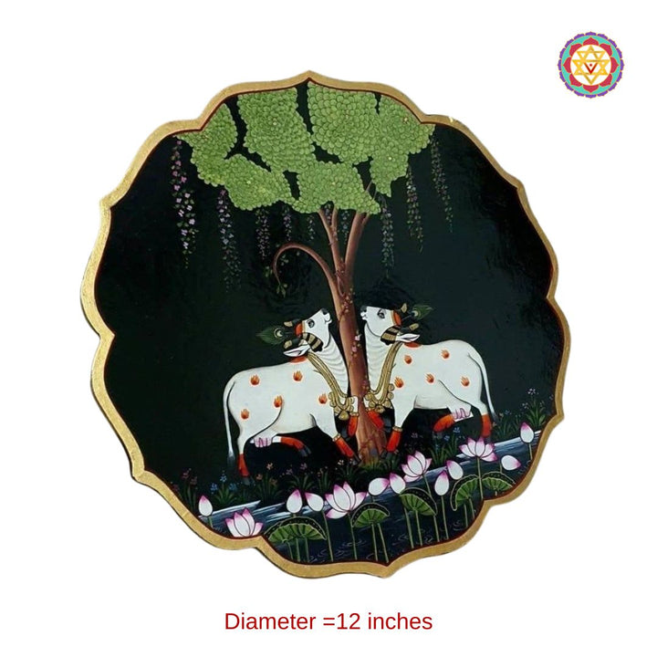 hand-painted petal-shaped pichwai wall plate depicting cows under the tree of life, symbolic and artistic design