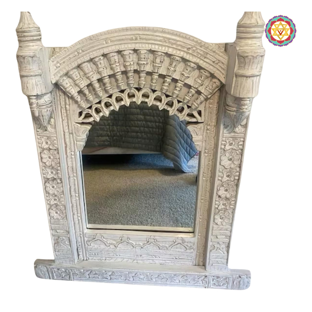 “Close-up of the handcarved wooden jharokha mirror frame with intricate floral and lattice patterns”