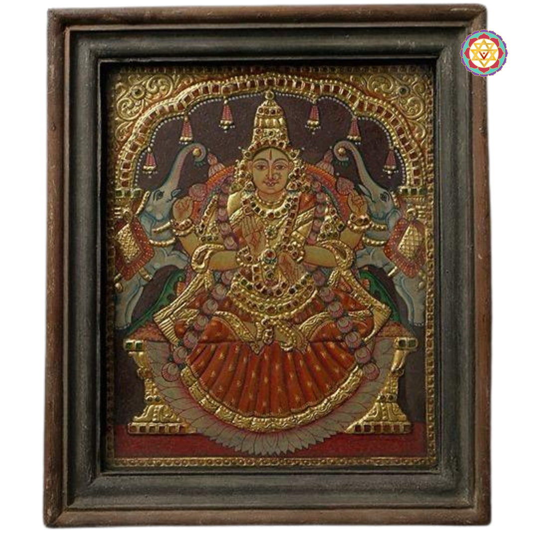 Full view of framed Gajalakshmi painting in antique-style wood frame