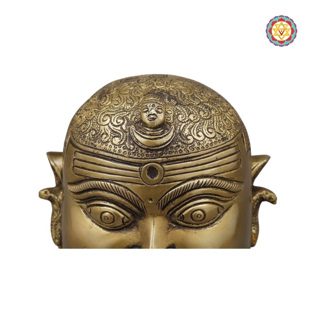 top-angle view of Shiva mask with polished golden texture