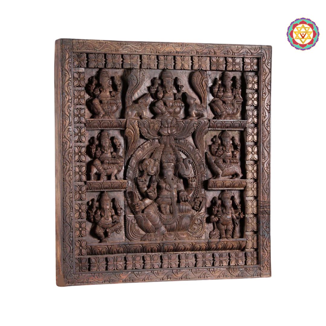 Angled view of the square wooden panel with deity carvings