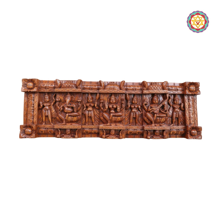 Horizontal devotional wall panel depicting Ganesha Lakshmi Saraswati in traditional carving