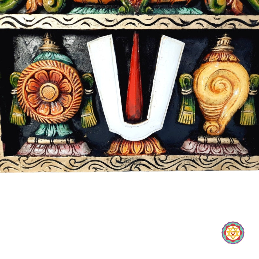 Detailed shot of Shankhu and Chakra symbols on Chettinad-style panel