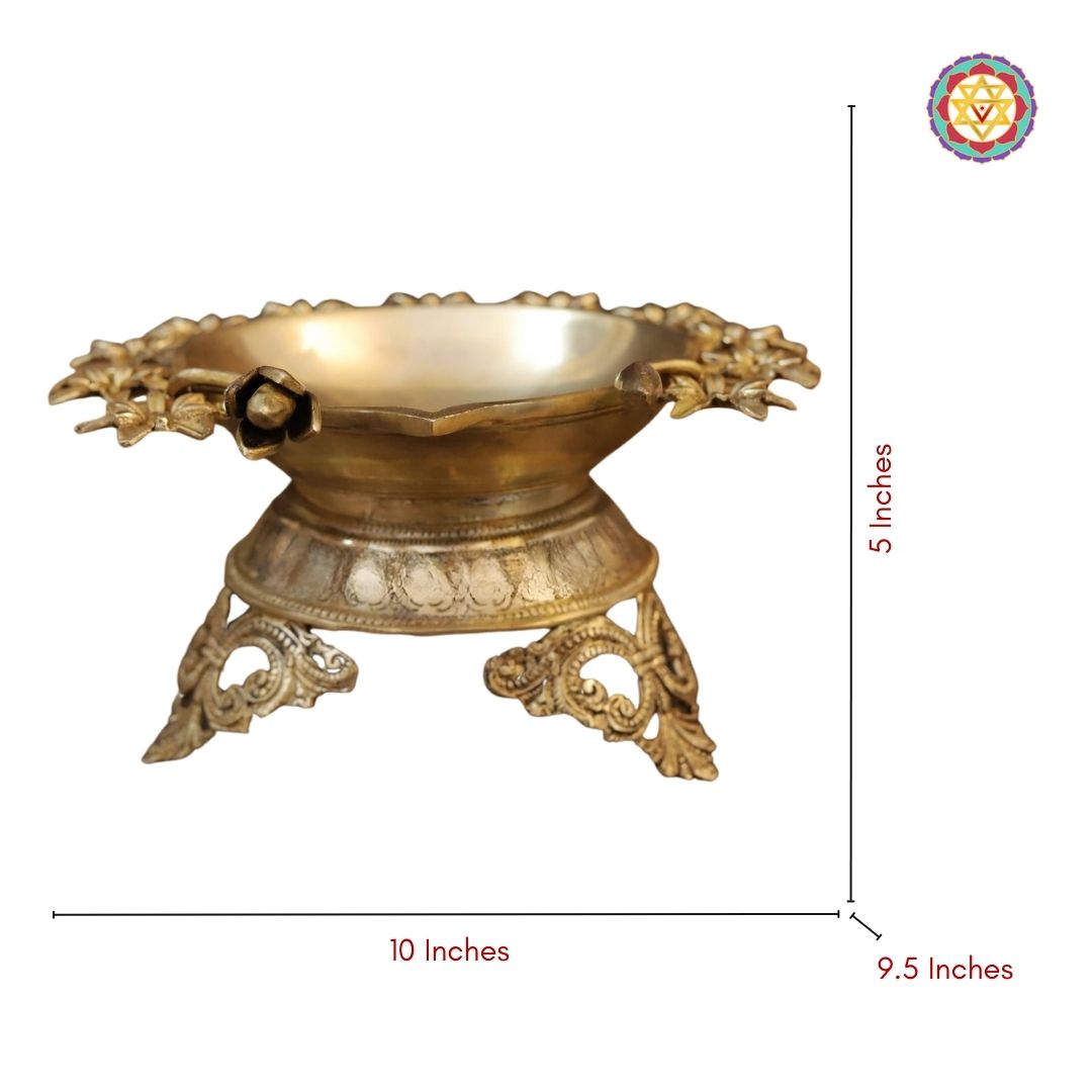 top-angle view of brass flower urli with polished golden surface