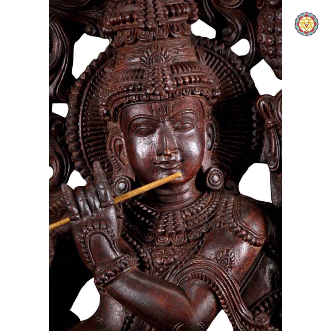 Side profile of Krishna statue showing intricate carving on base and cow figure detailing