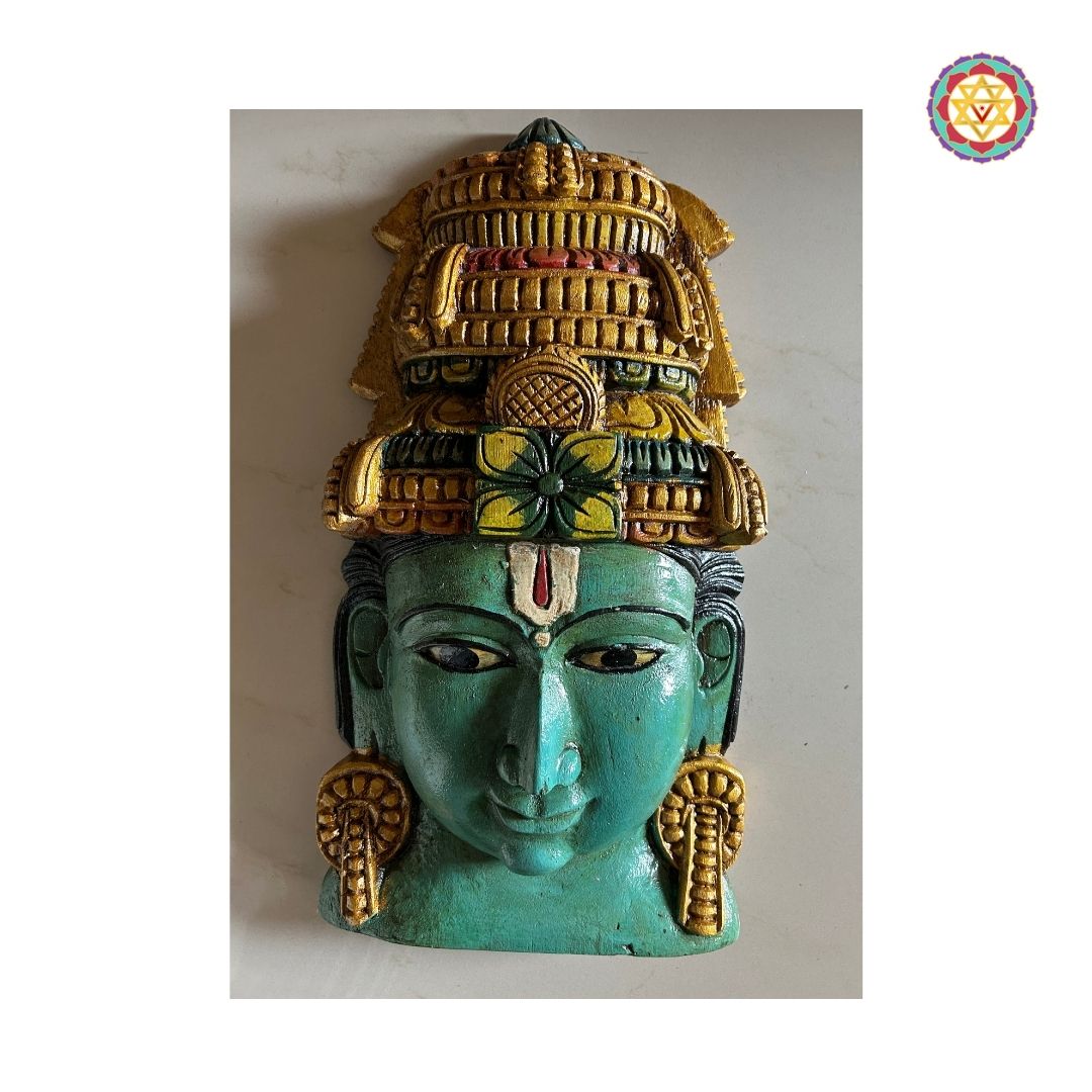 Close-up of Vishnu mask with antique blue patina and detailed carving