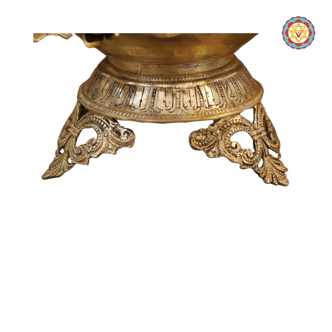 close-up of engraved base on brass urli showing detailed craftsmanship