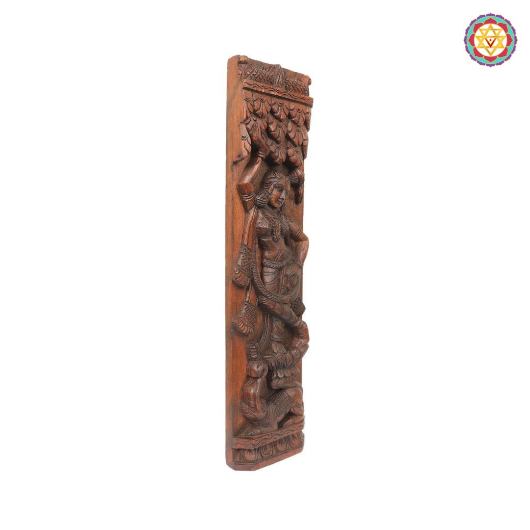 handcarved apsara sculpture close up highlighting fine carving in forest backdrop