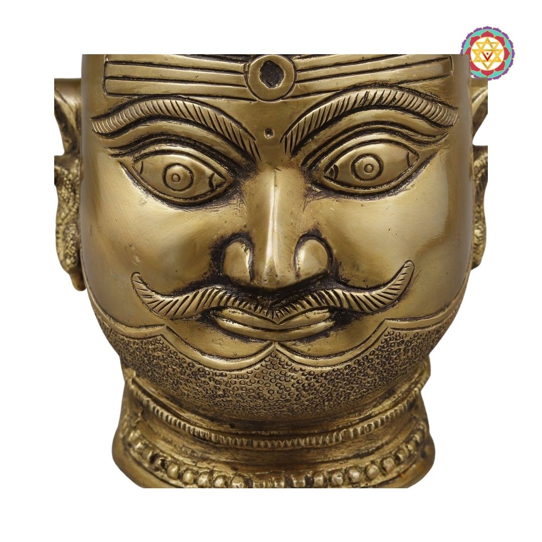 Shiva brass mask displayed against background highlighting rustic charm