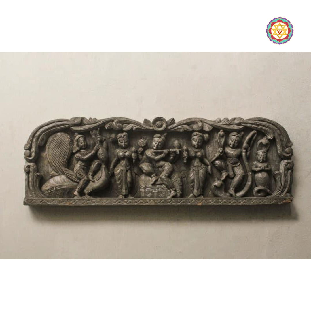 Carved Krishna wall panel showing gopikas and cow figures