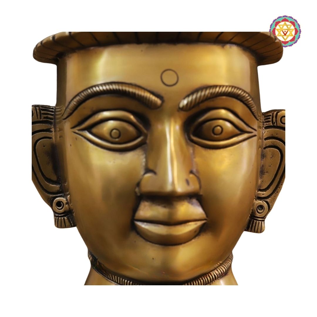 detailed view of crown motifs and floral carvings on the Parvati head statue