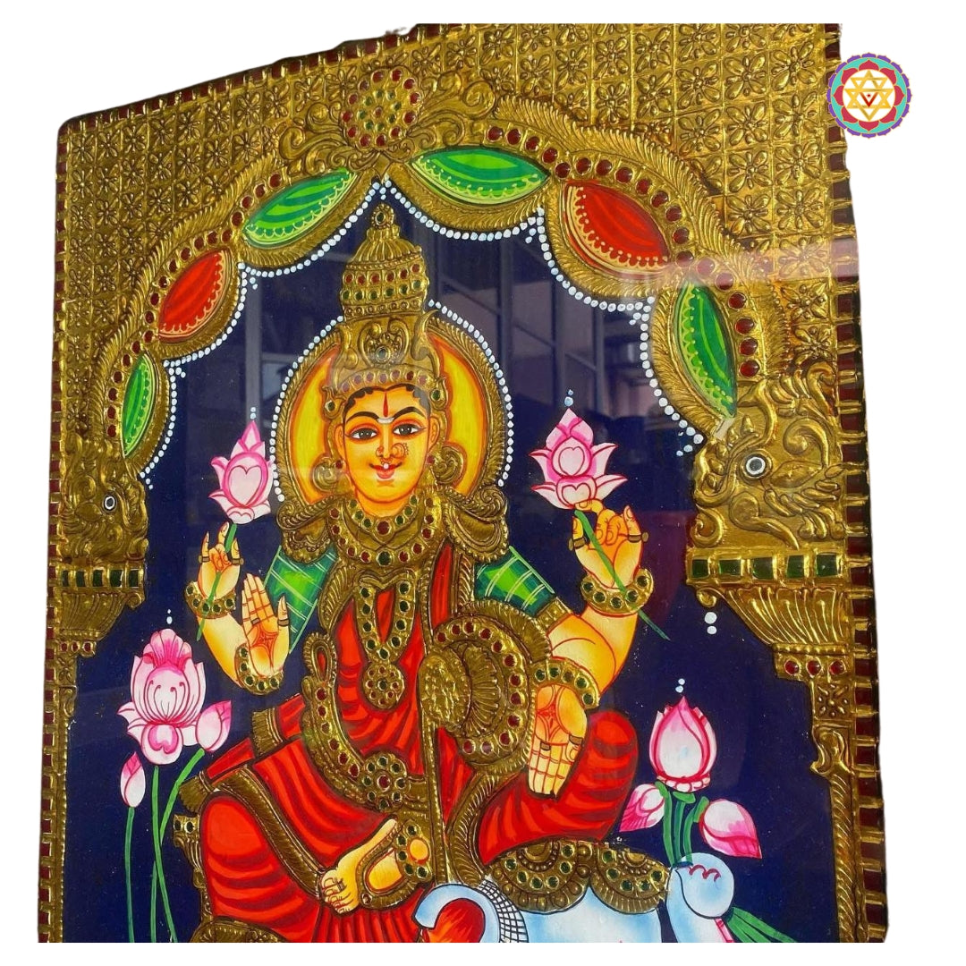 Detailed view of Gajalakshmi surrounded by pink lotuses and golden arch