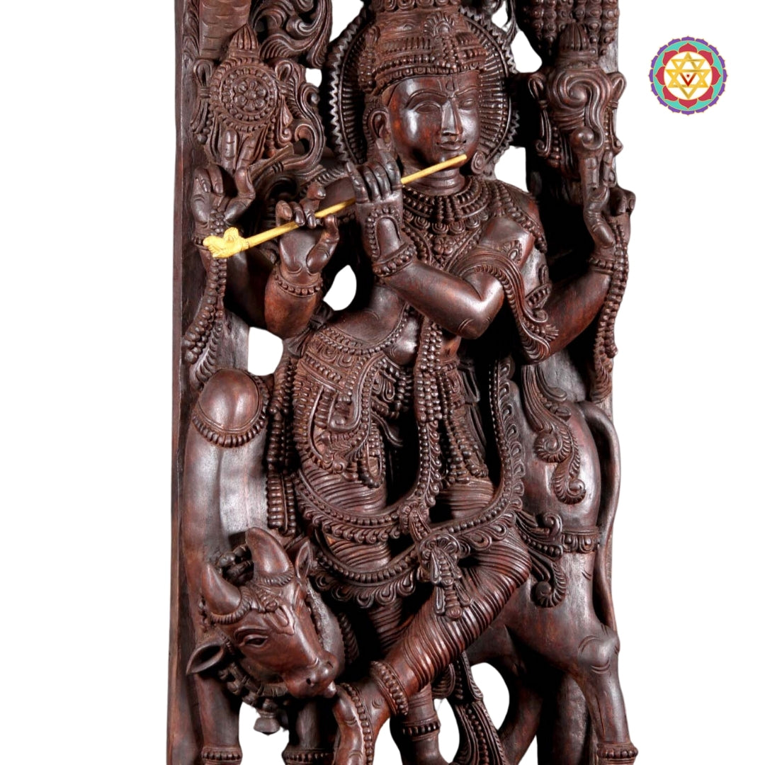 Front view of Krishna sculpture showing cow beneath canopy in devotional posture