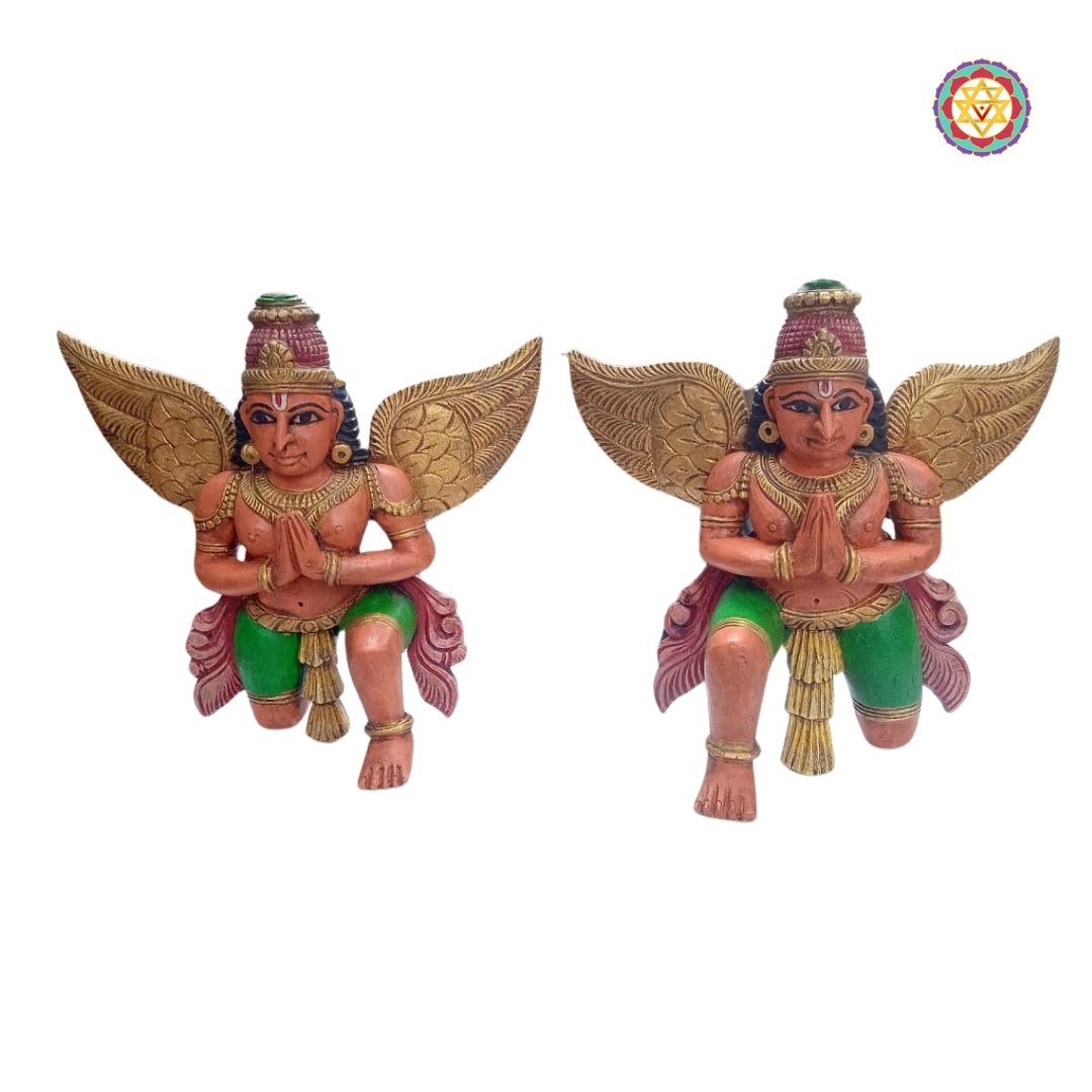 Detailed close-up of Garuda wooden statue base and wing texture — intricate hand-carved woodwork, gold brown tones