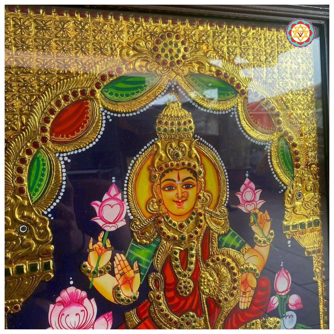 Embossed gold detailing of Lakshmi Tanjore painting with divine aura
