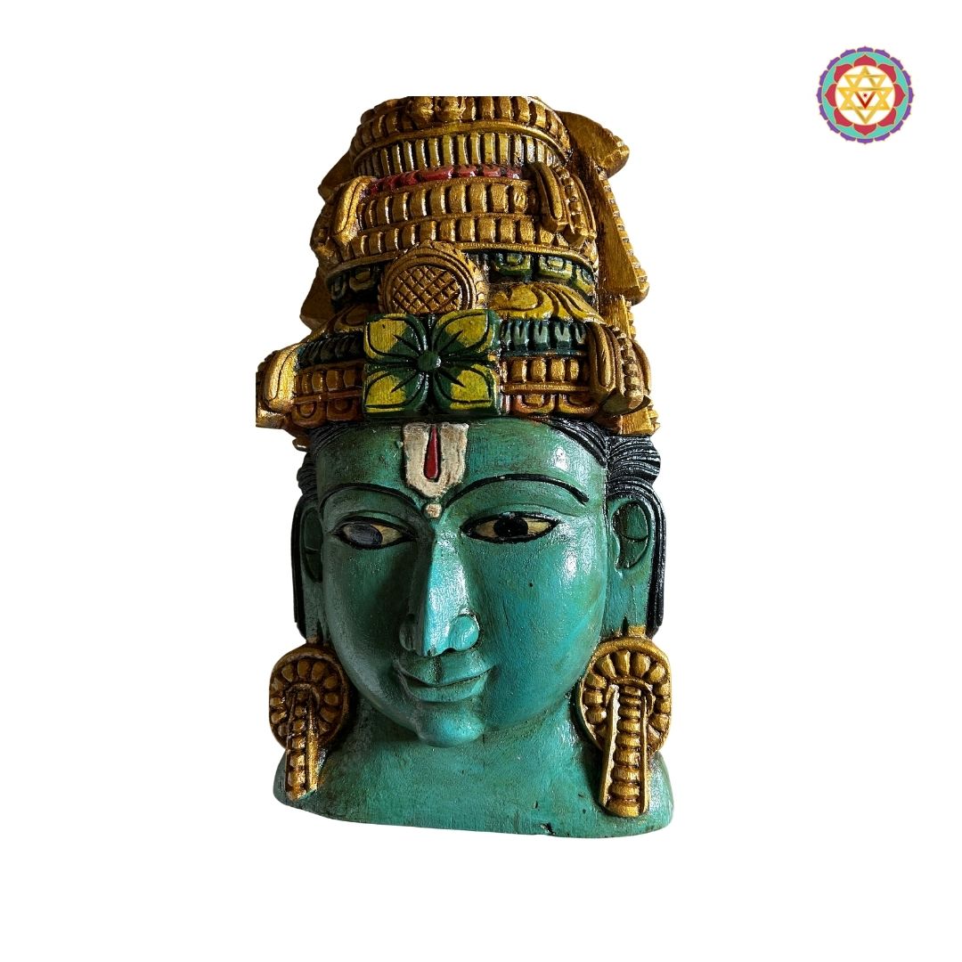 Detailed carving on Vishnu mask showing serene facial expression