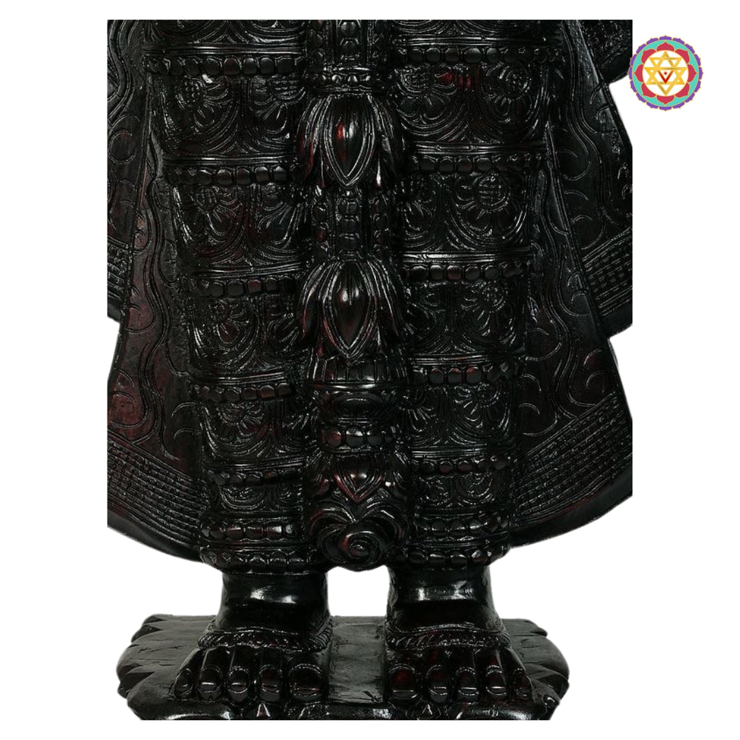 polished teak perumal idol photographed with soft studio lighting