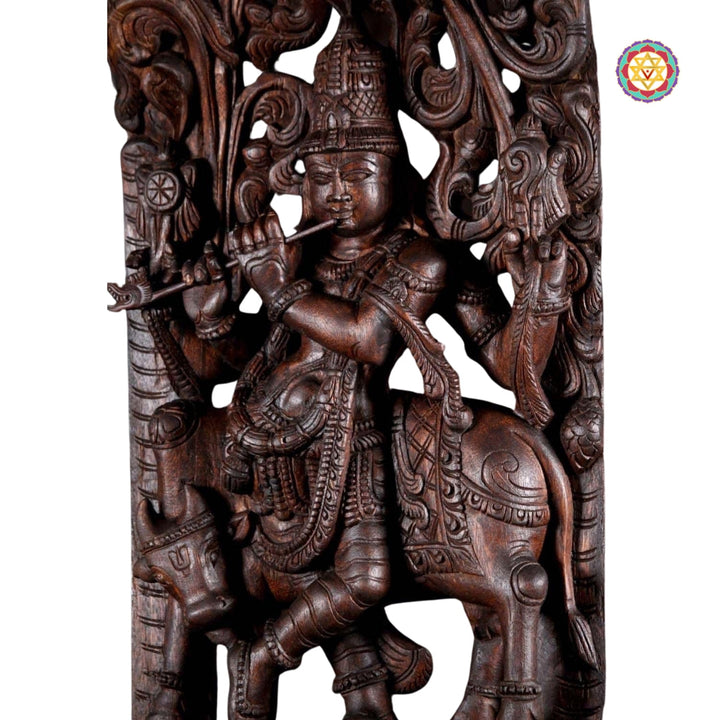Handcarved Lord Krishna statue with cow beneath floral arch design