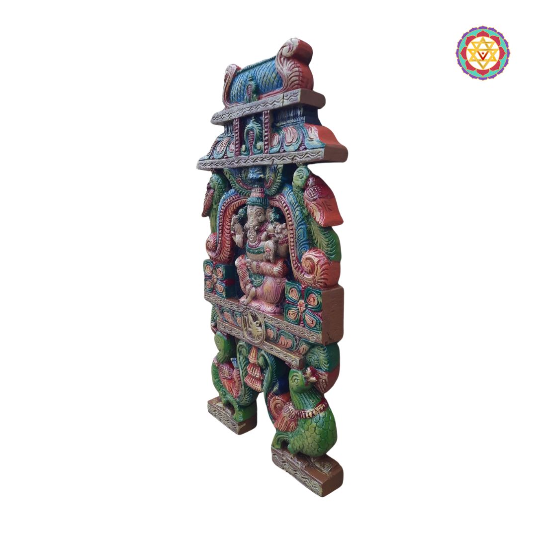 Wall-mounted Ganesha panel above seating with light decor