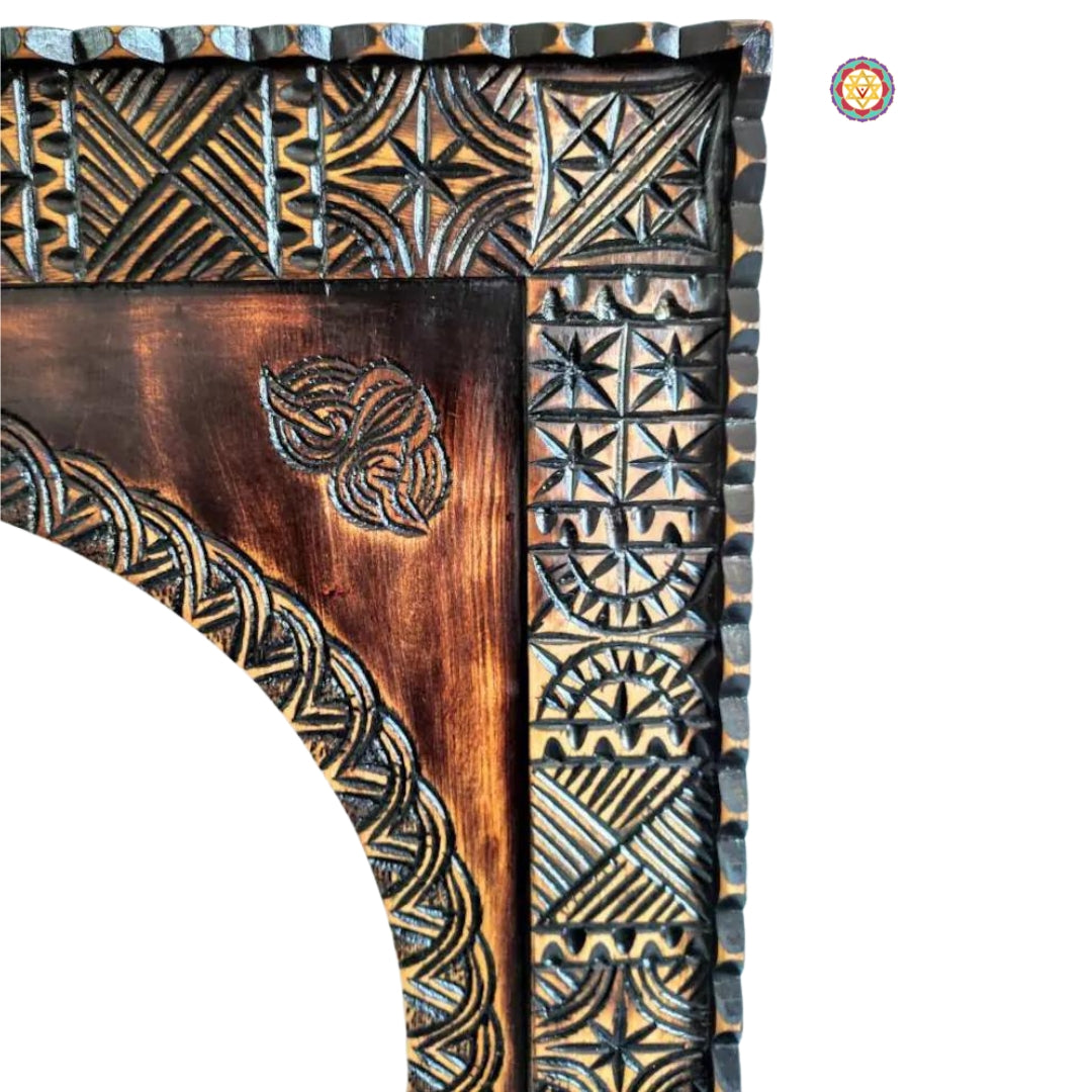 Carved corner of a vintage wood frame with ornate pattern